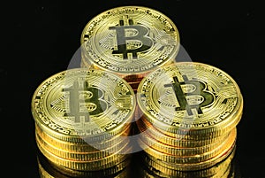 Stack of Bitcoins cryptocurrency on a black background