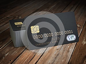 Stack of black blank credit cards mockup on wooden table backgr