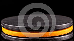 A stack of black and orange discs.