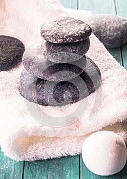 Stack of black stones on white towel