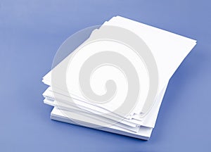 The Stack of blank A4 paper sheets on blue background