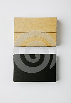 Stack of blank black business cards and craft Cards box on white background. Vertical