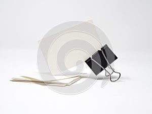 Stack of blank business cards and a blank business card held by binder clip