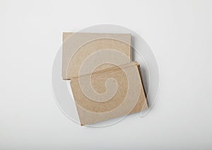 Stack of blank craft business cards on white background with soft shadows.