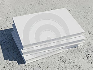 Stack of blank white paper sheets on concrete surface