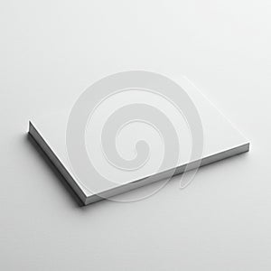 A stack of blank, white rectangular sheets of paper is shown on a plain, smooth