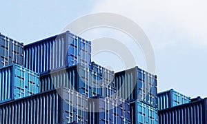 Stack of blue container boxes with sky background. Cargo freight shipping for import and export logistics. Business and