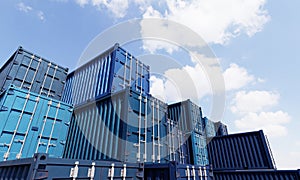 Stack of blue container boxes with sky background. Cargo freight shipping for import and export logistics. Business and