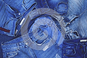 Stack blue jeans background. Denim texture.