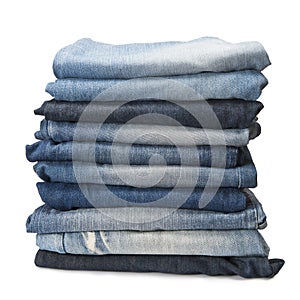 Stack of blue jeans over a white background