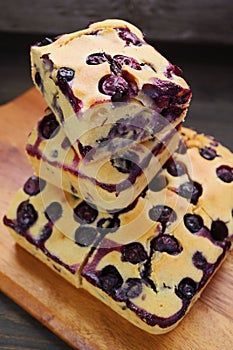 Stack of Blueberry Cake Slices on Wooden Breadboard