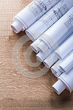 Stack of blueprint rolls on wooden oaken board