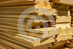 Stack of boards. Industrial background. Floor boards. Larch boards. Boards with grooves