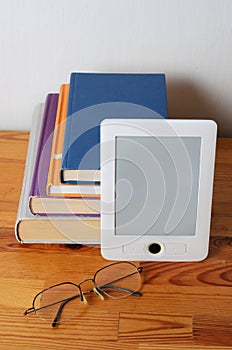 Stack of book and ebook reader
