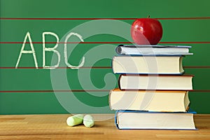 Stack of book and red apple