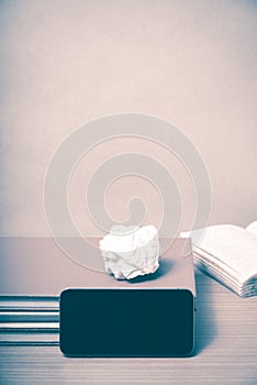 Stack of book with smart phone vintage style