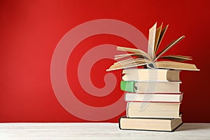 Stack of books against red background