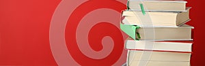 Stack of books against red background