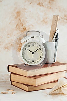 Stack of Books with Alarm Clock. Time for reading, concentration in study, homework or educational concept. Copy space