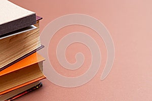 Stack of books on a beige background.