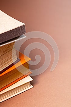 Stack of books on a beige background.