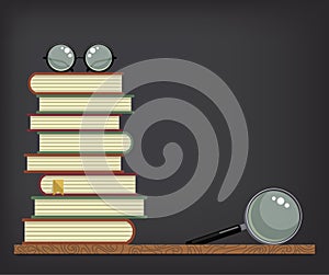 Stack of books on blackboard