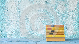 Stack of books on blue wall