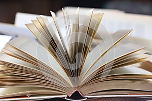 stack of books, close up. Open book on the table in library. Back to school concept.