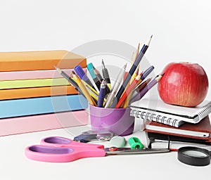 Stack of books and colorful school supplies on white background.photo with copy space