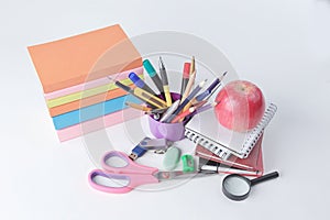 Stack of books and colorful school supplies on white background.photo with copy space