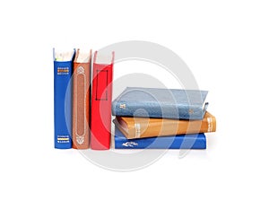 Stack of books in colour covers with white sheets