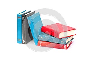 Stack of books in colour covers with white sheets