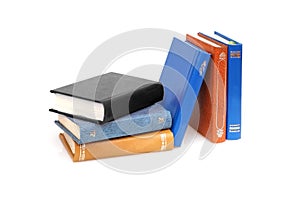 Stack of books in colour covers with white sheets