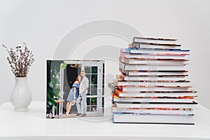 stack of books. cover photobook from photo shoot of a beautiful happy couple