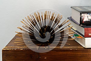 a stack of books are on a desk near a bookshel