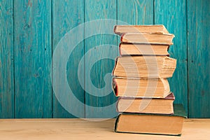 stack of books on the desk over wooden background