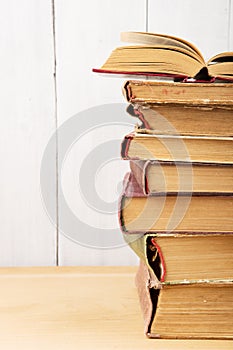 stack of books on the desk over wooden background