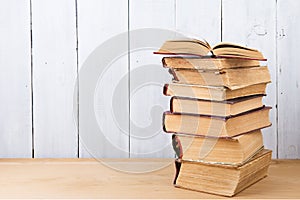 stack of books on the desk over wooden background