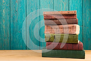 stack of books on the desk over wooden background