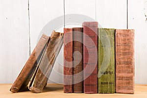 stack of books on the desk over wooden background