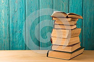 stack of books on the desk over wooden background