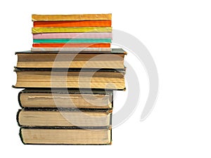 A stack of books of different format and thickness isolated on a white background. Clean place for text. Background for libraries