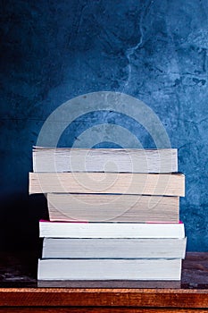 Stack of books on dusty table