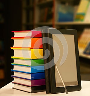 Stack of books with e-book reader