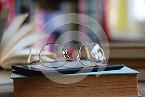 Stack of Books, E-Reader and Glasses