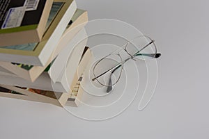 A stack of books and glasses
