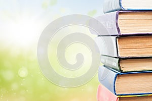 Stack of books on green background