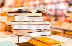 Stack of books lying on table in bookstore