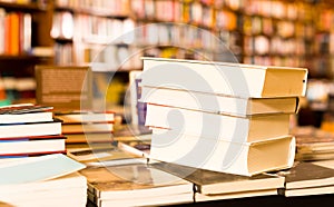 Stack of books lying on table in bookstore