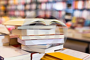 Stack of books lying on table in bookstore